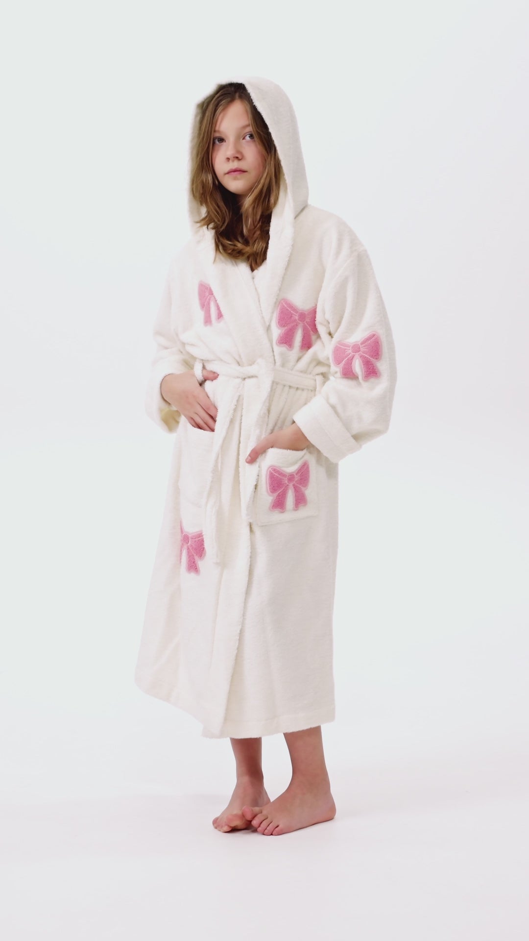 Girl in white bathrobe with bows 